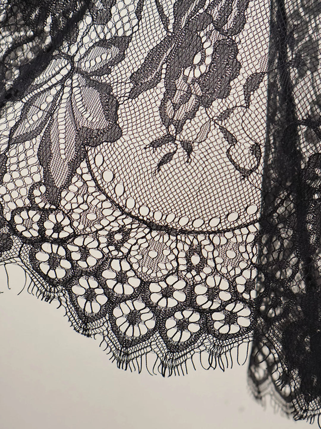 Close-up of the black eyelash lace scalloped edge on the overlay skirt
