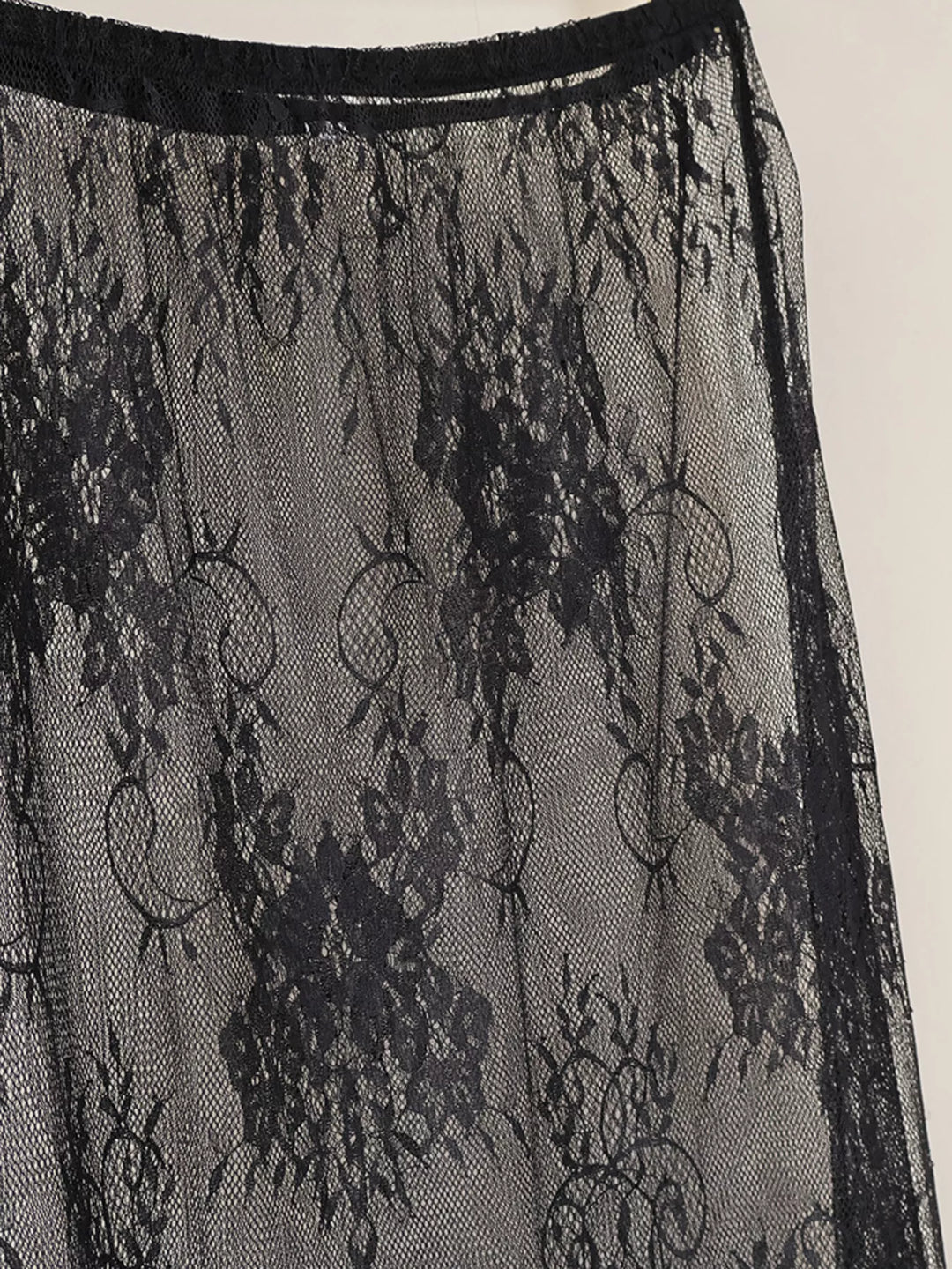 Close-up of the black floral lace overlay skirt and waistband