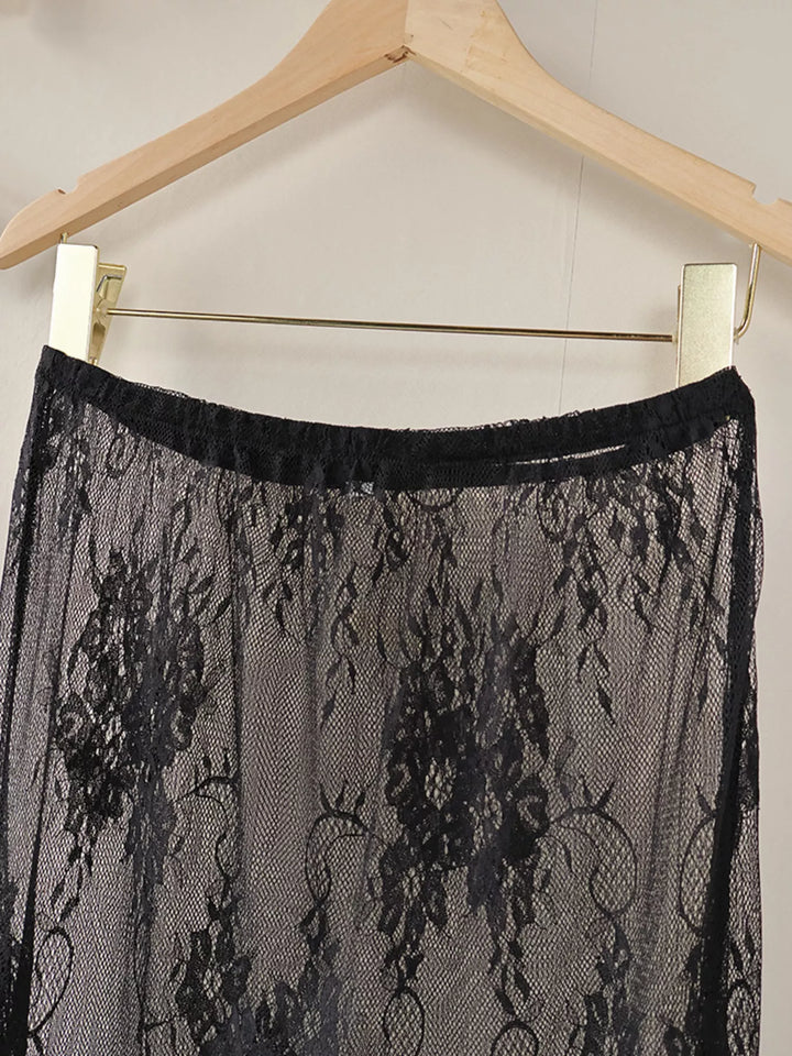 Black sheer floral lace overlay skirt on a hanger, upper section