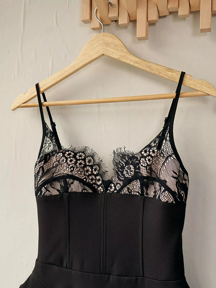 Black lace corset bodice on a wooden hanger, front detail
