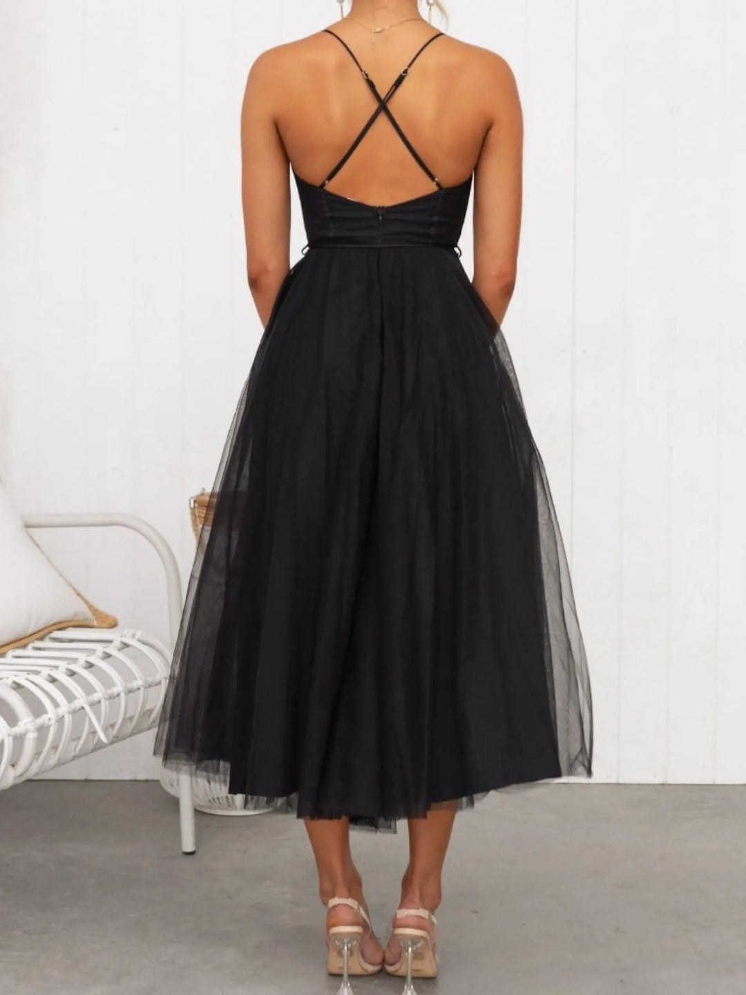 Black midi dress worn on a model, showing the layered tulle skirt