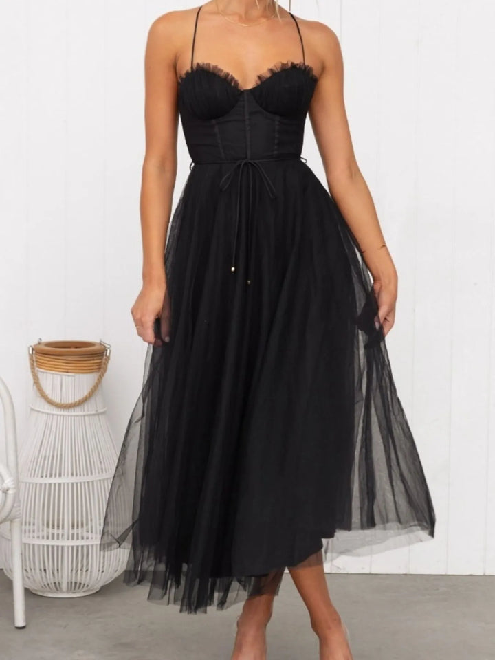 Black midi dress worn on a model, showing the sweetheart neckline