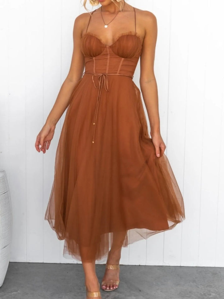 Caramel midi dress worn on a model, showing the corset bodice