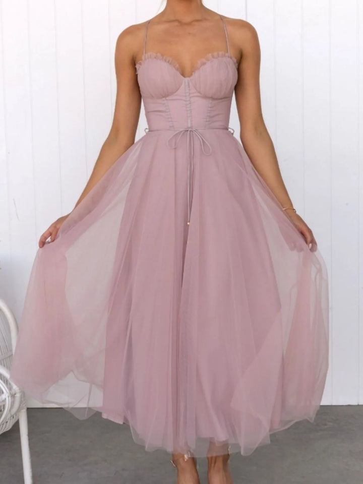 Pink midi dress worn on a model, showing the corset bodice