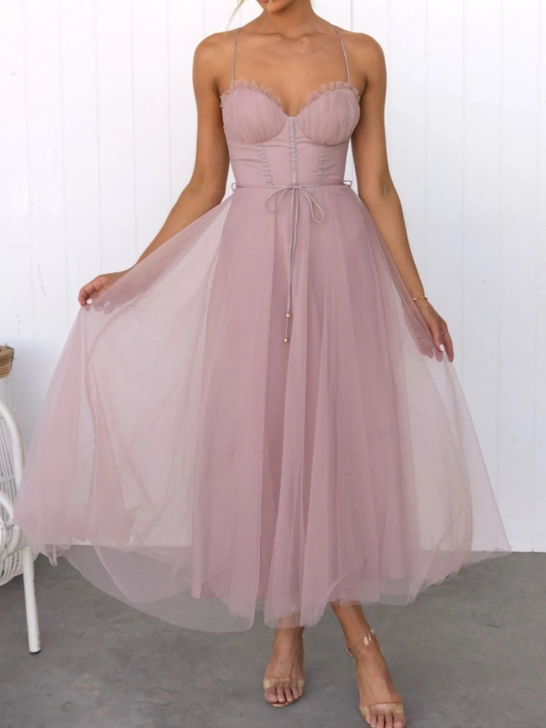 Pink midi dress worn on a model, showing the layered tulle skirt