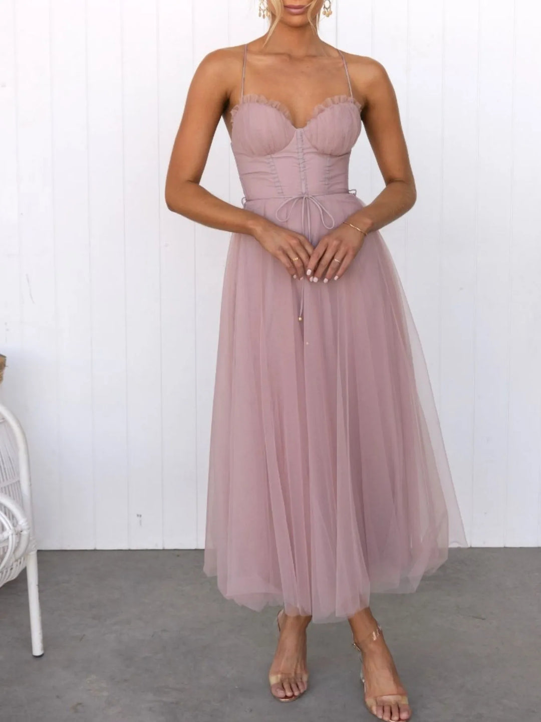 Pink midi dress worn on a model, showing the thin straps