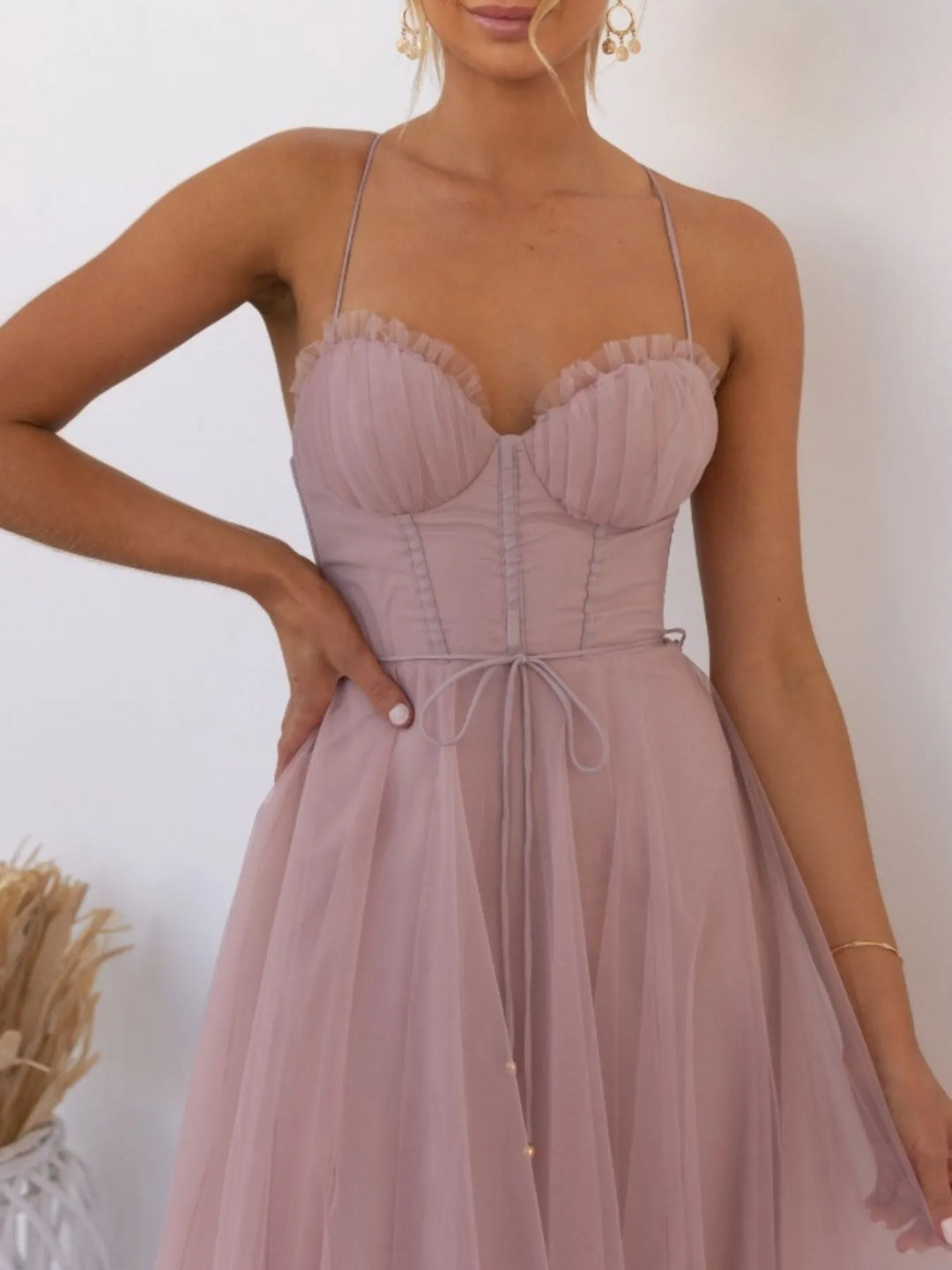 Pink midi dress worn on a model, showing the sweetheart neckline