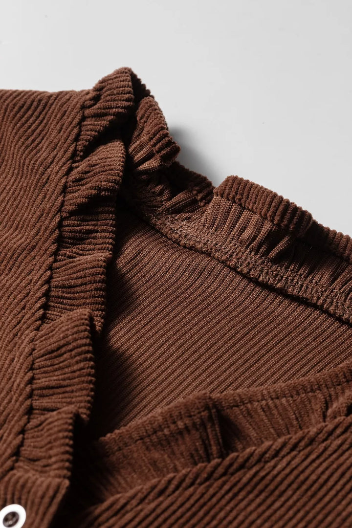 Close-up of the ruffle trim along the neckline of the brown corduroy blouse