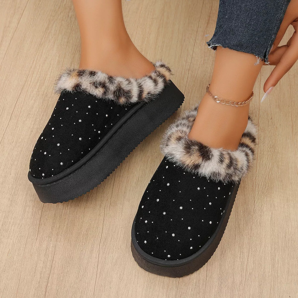 Black platform slippers with leopard trim and sparkly studs, worn with cuffed jeans