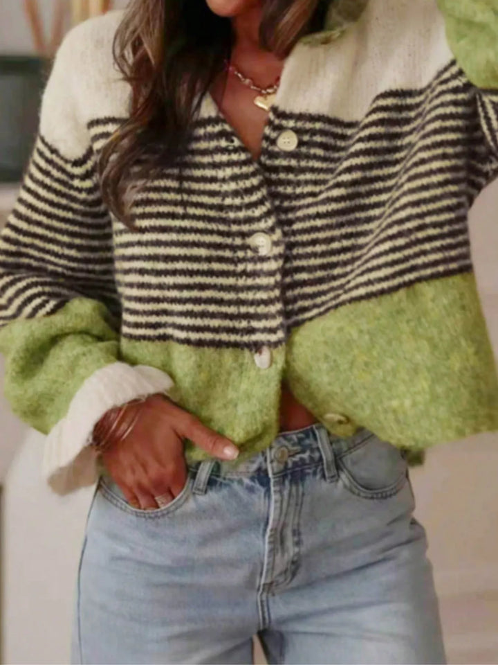 Green color block cropped cardigan with black stripes, hands in jeans pockets