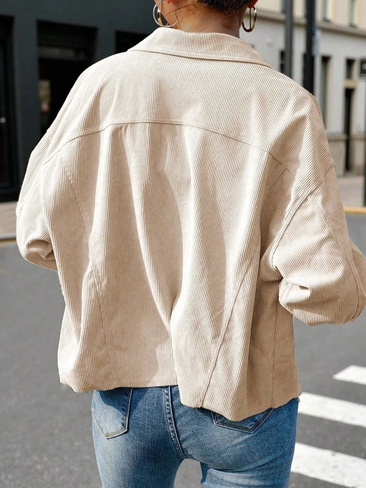 Back view of the beige cropped shirt style jacket