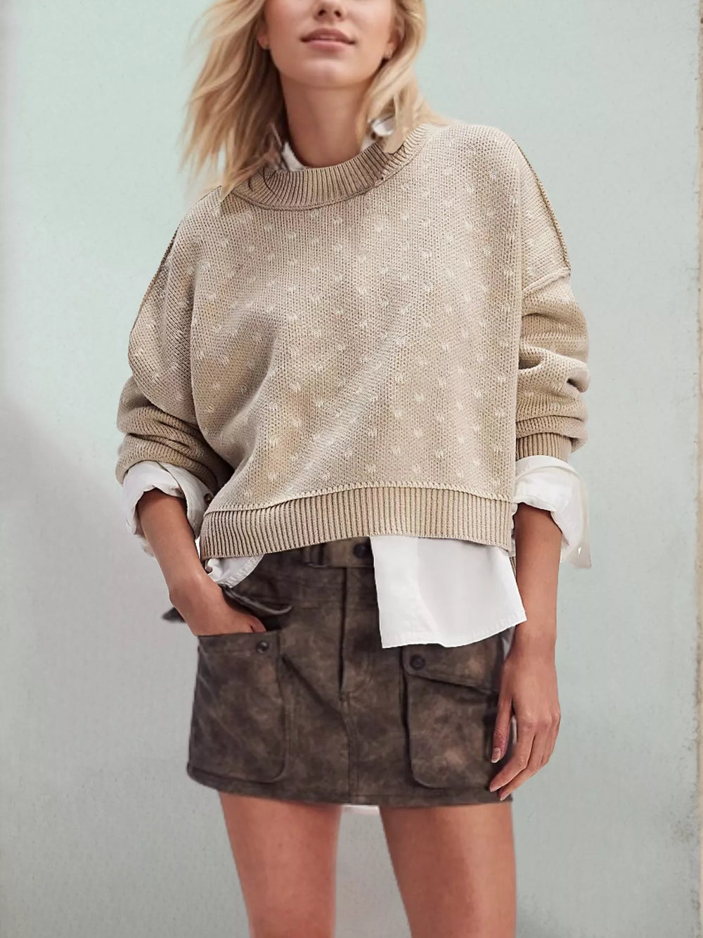 Beige heart pattern sweater styled with a cargo mini skirt and white shirt