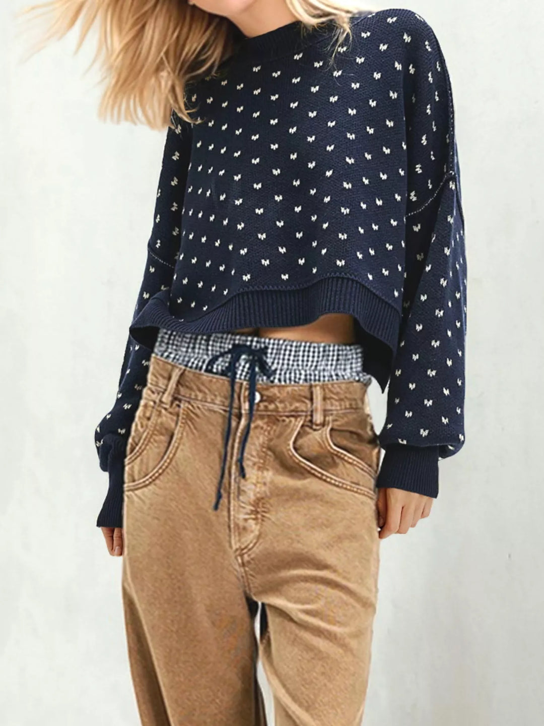 Navy cropped sweater with heart pattern worn with corduroy pants and a drawstring waistband