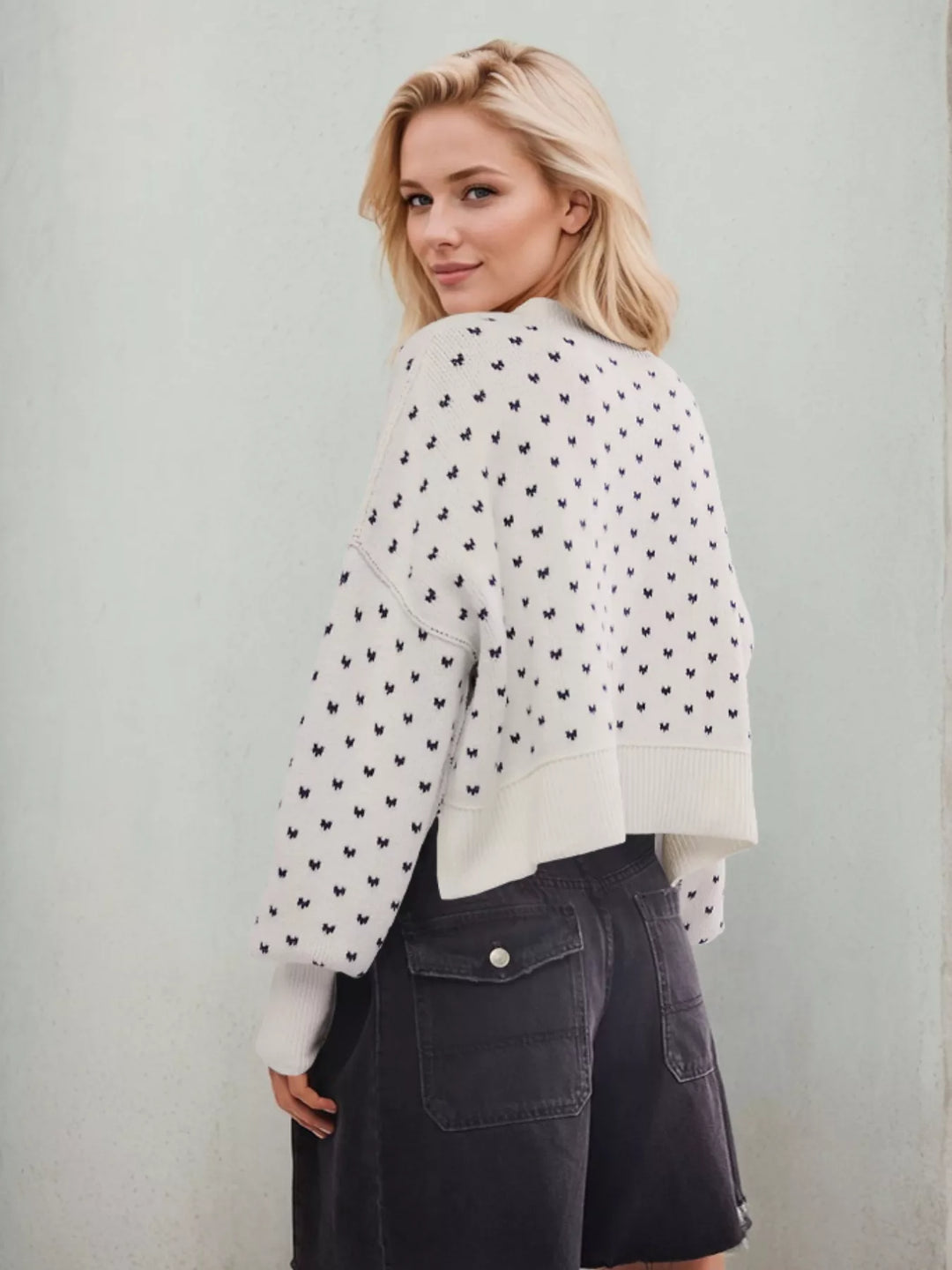 Side view of the white heart pattern sweater with black shorts