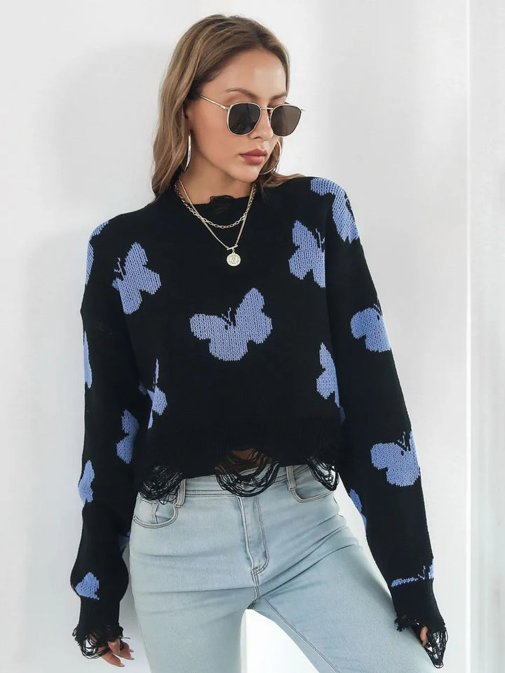 Black butterfly cropped sweater with hands on hips, front view