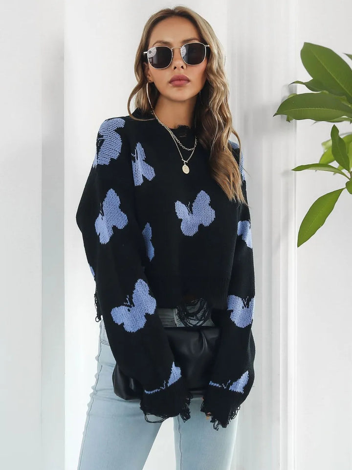 Side view of the black cropped sweater with frayed hem