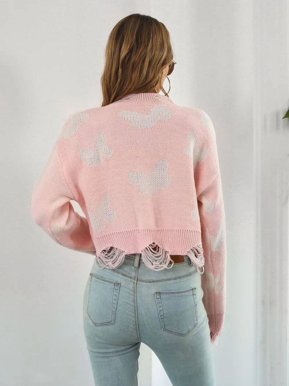 Back view of the blush pink cropped sweater with butterfly print