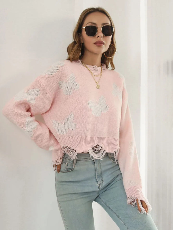 Blush pink crew neck cropped sweater in a relaxed side pose