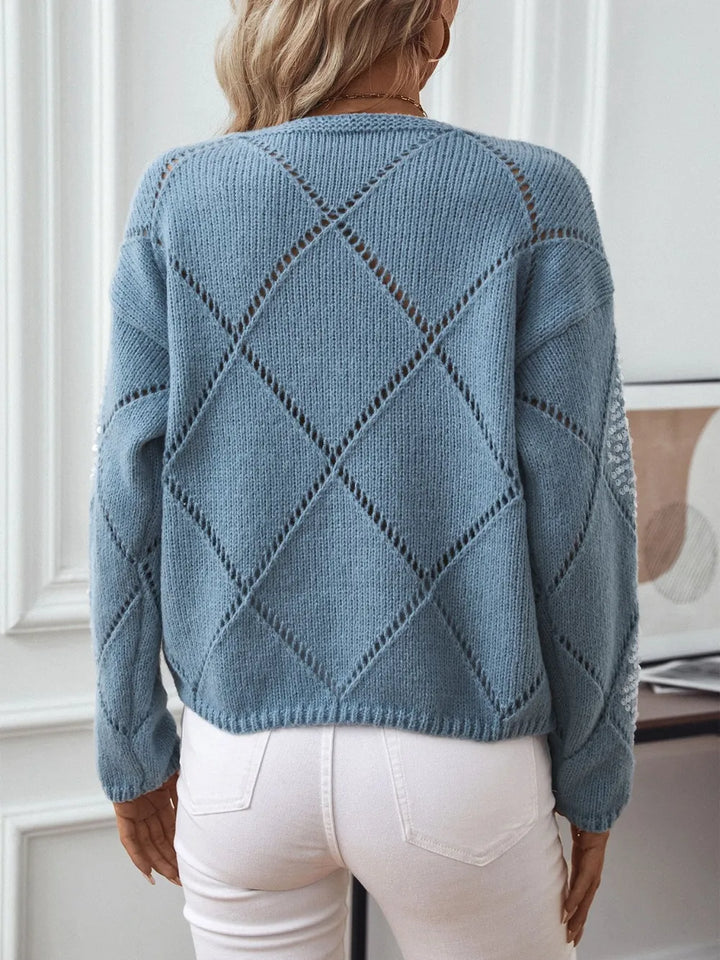 Back view of the dusty blue openwork knit sweater with diamond pattern