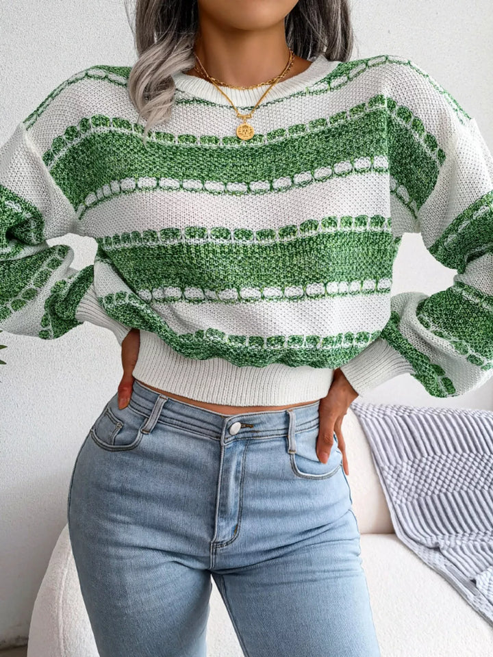 Green wide stripe sweater with hand on hip and high waisted jeans