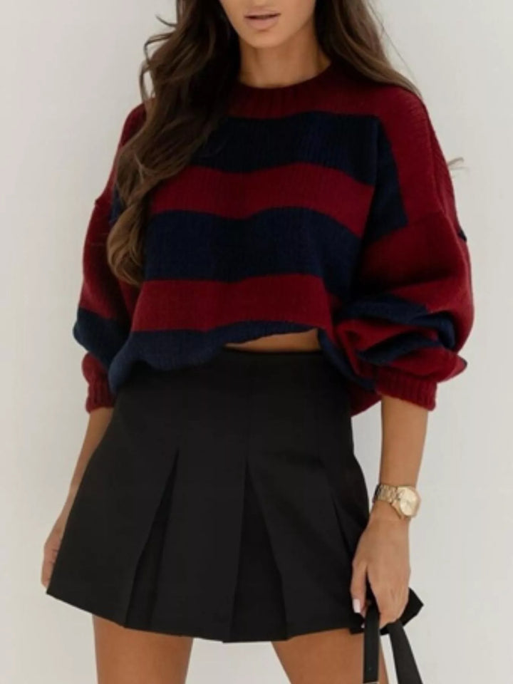 Burgundy navy cropped sweater styled with a black skirt, front view