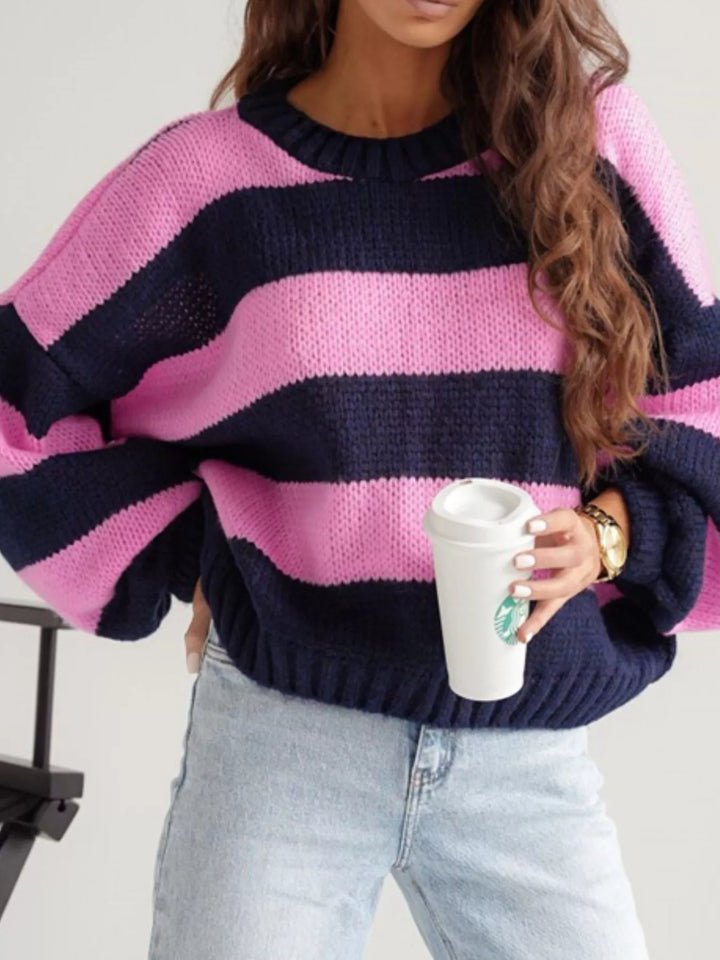 Pink and navy wide stripe cropped sweater with balloon sleeves, holding a cup
