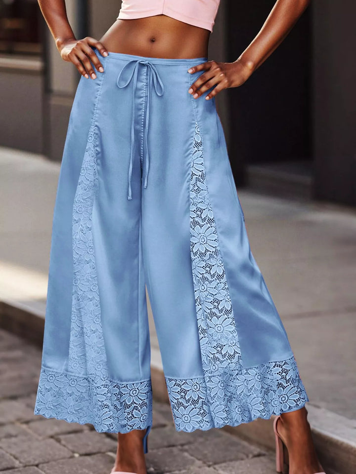 Women's cropped wide leg pants in light blue with satin look and lace panels, front view