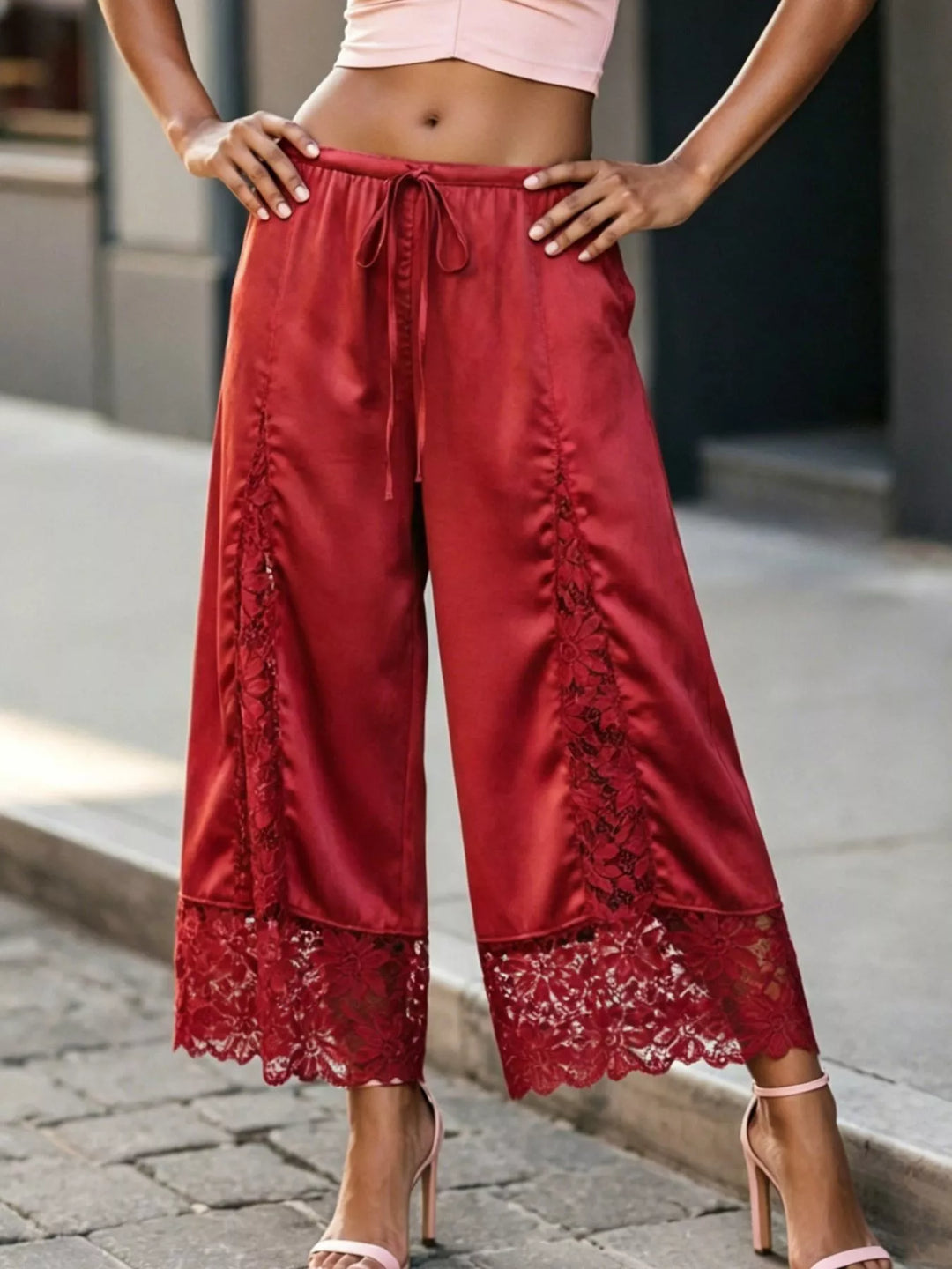 Full-length red satin look pants with a lace panel and scalloped lace hem