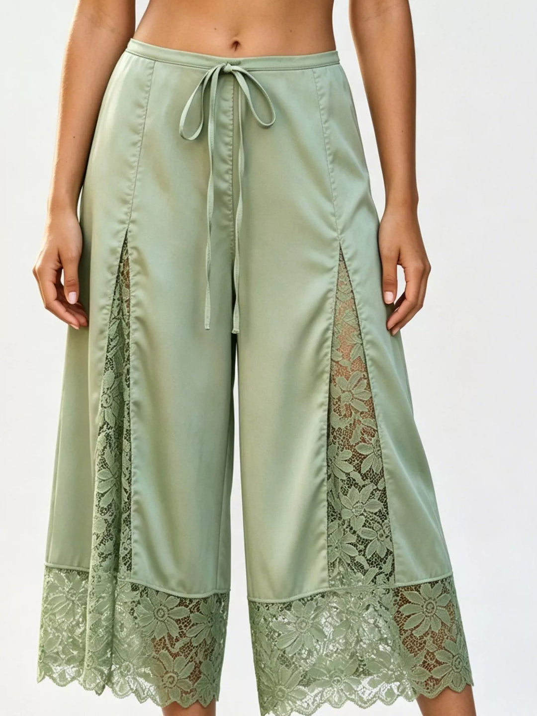 Sage green lace panel pants styled with a pink crop top and open toe heels