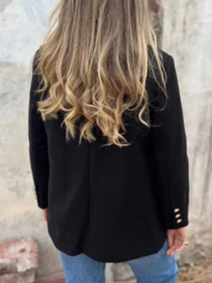 Back view of the black relaxed blazer with hip length cut