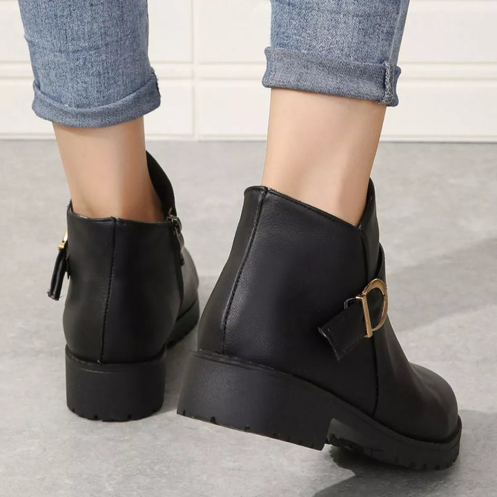 Back view of black ankle boots showing the heel and side zipper