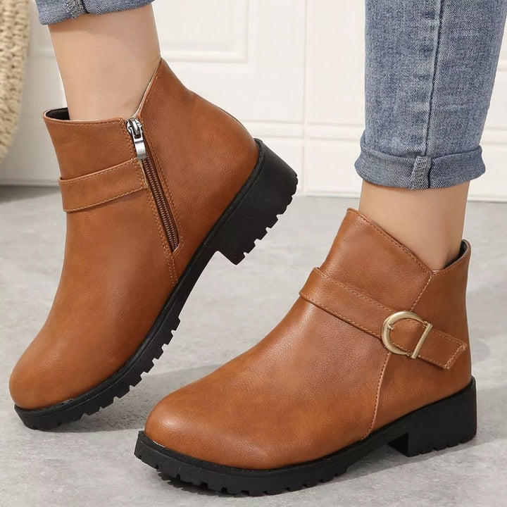 Cognac fall boots with gold buckle and side zipper worn with rolled jeans
