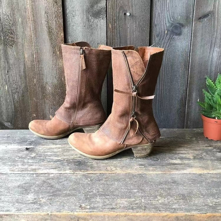 Side view of brown mid calf boots with the curved zipper and pull tab
