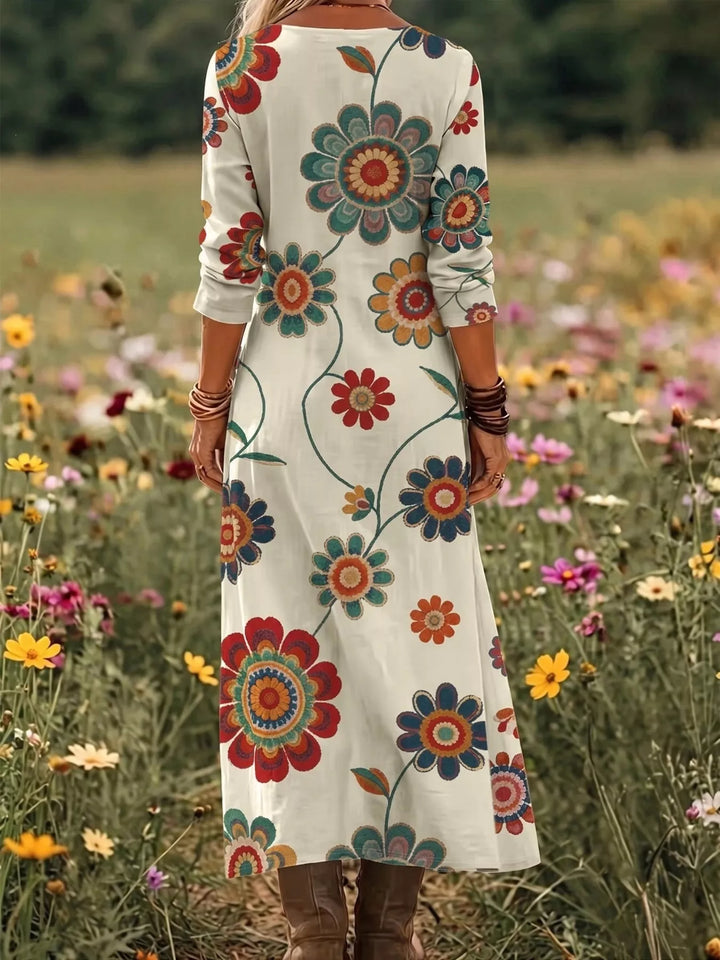 Beige maxi dress worn on a model, showing the medallion floral print