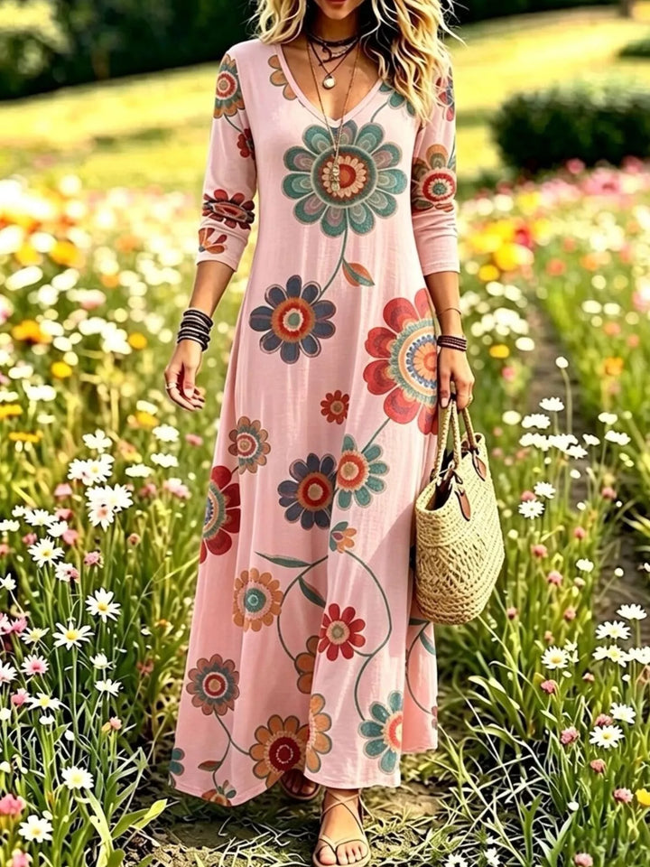 Dusty pink maxi dress worn on a model, showing the medallion floral print