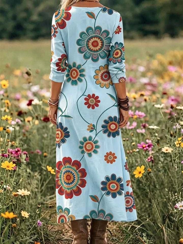 Sky blue maxi dress worn on a model, showing the medallion floral print