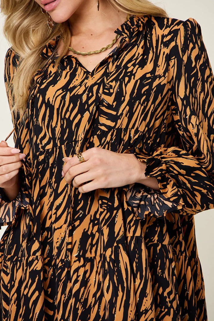 Close-up of the all-over animal print on the caramel mini dress