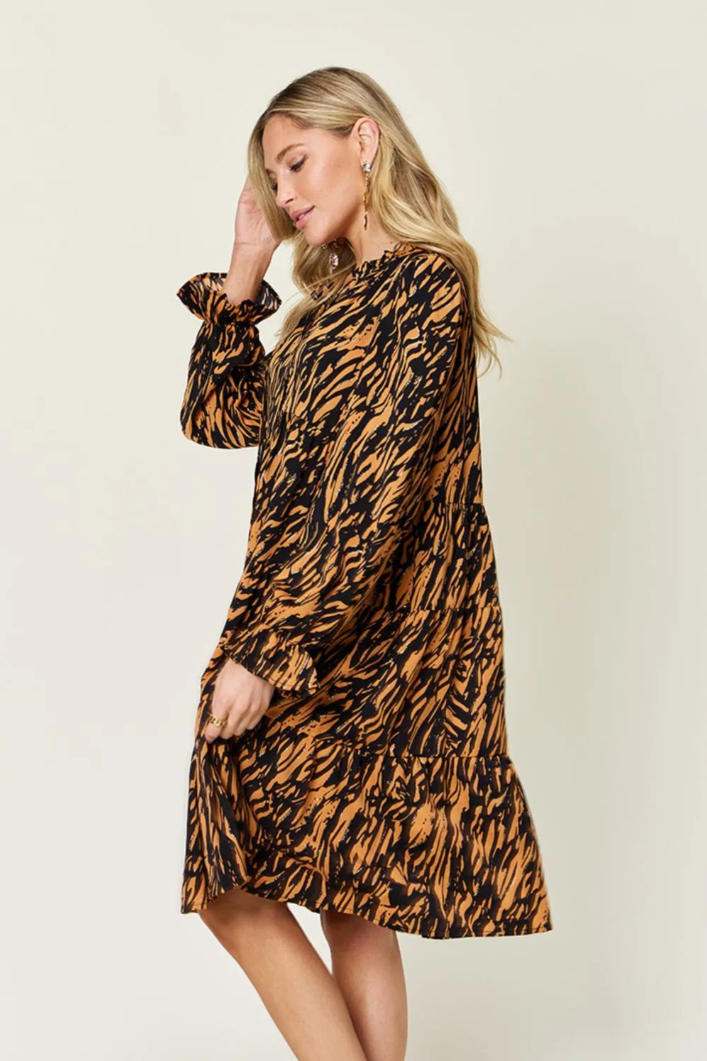 Caramel mini dress worn on a model, showing the long sleeves