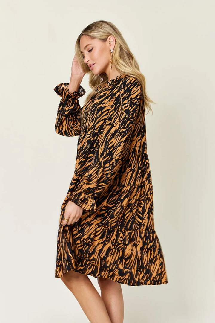 Caramel mini dress worn on a model, showing the long sleeves