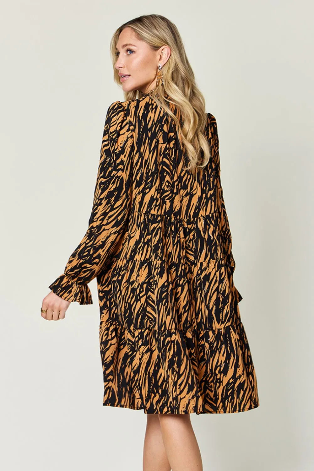 Caramel mini dress worn on a model, showing the relaxed fit
