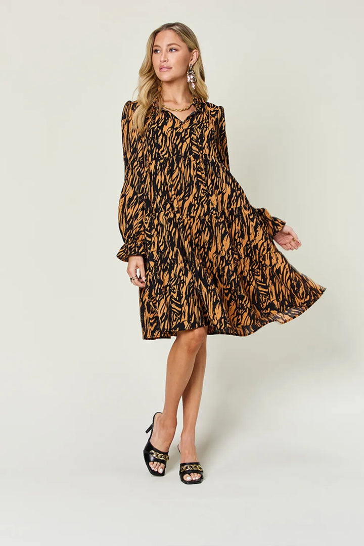 Caramel mini dress worn on a model, showing the all-over animal print again