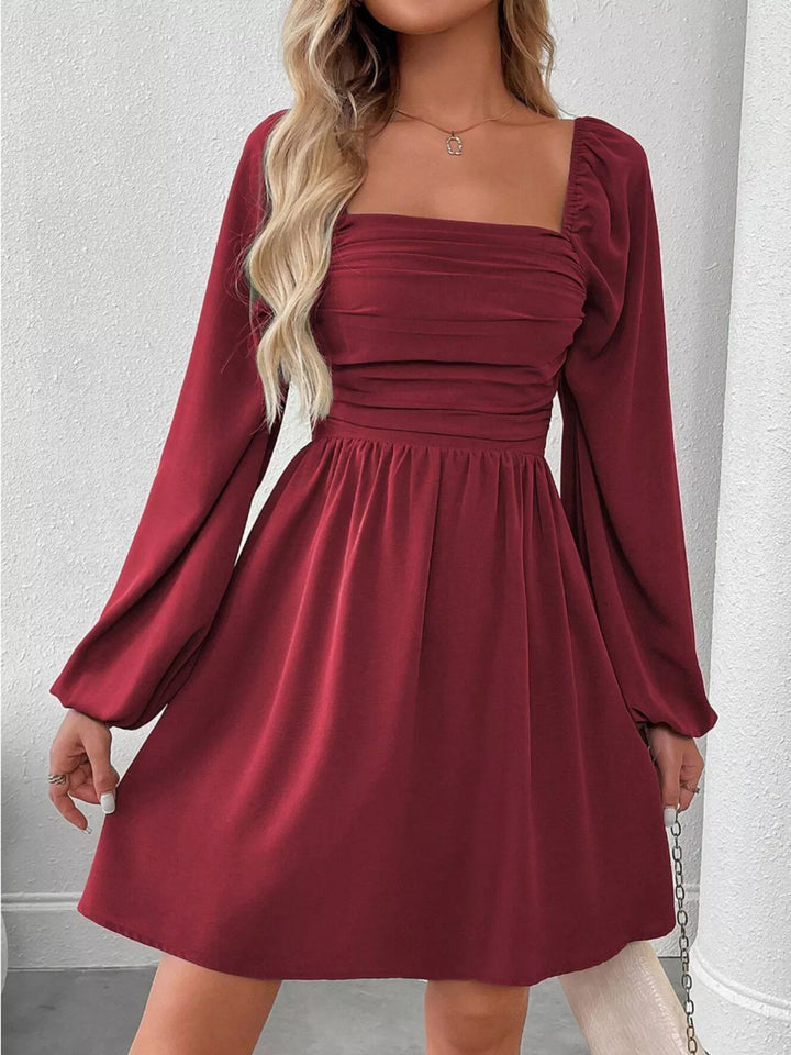 Wine red mini dress worn on a model, showing the square neckline