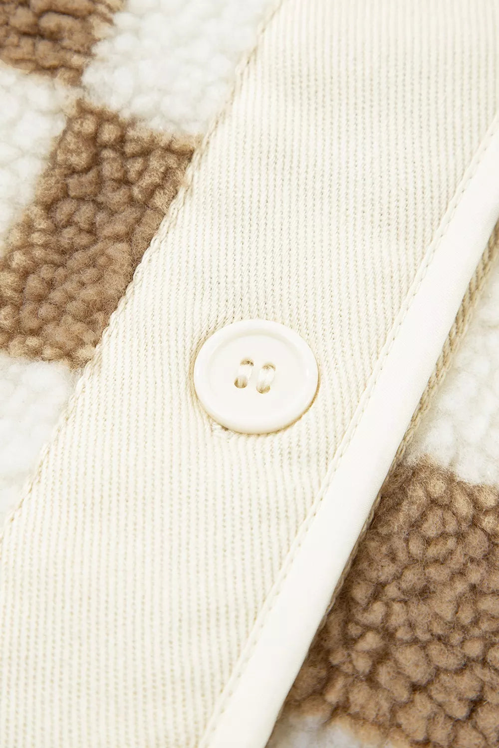 Close-up of the button placket and corduroy facing on the checkerboard jacket