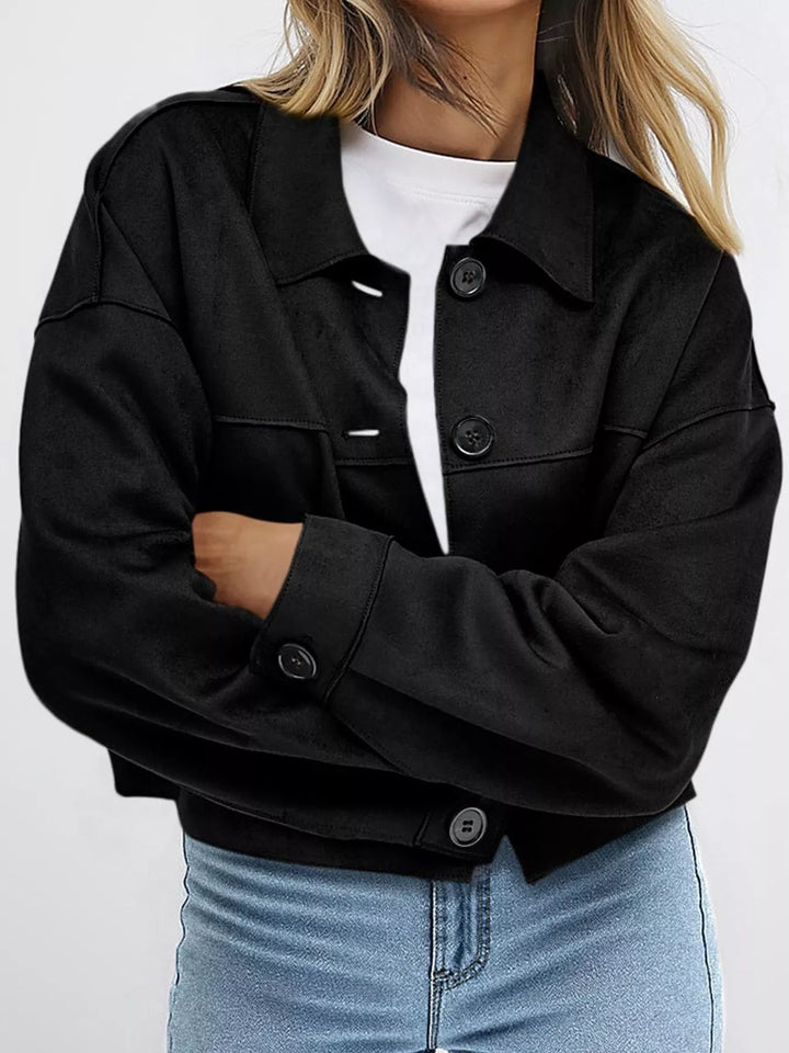 Black button front jacket with arms crossed, front view