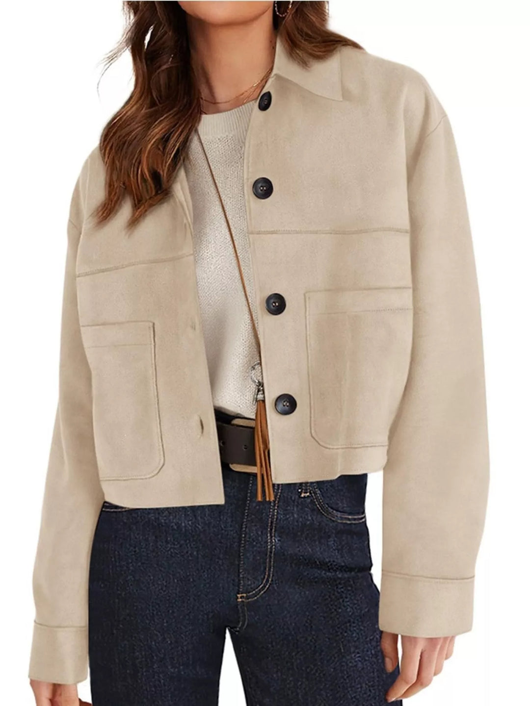 Sand cropped jacket with chest pockets, angled view with a crossbody strap