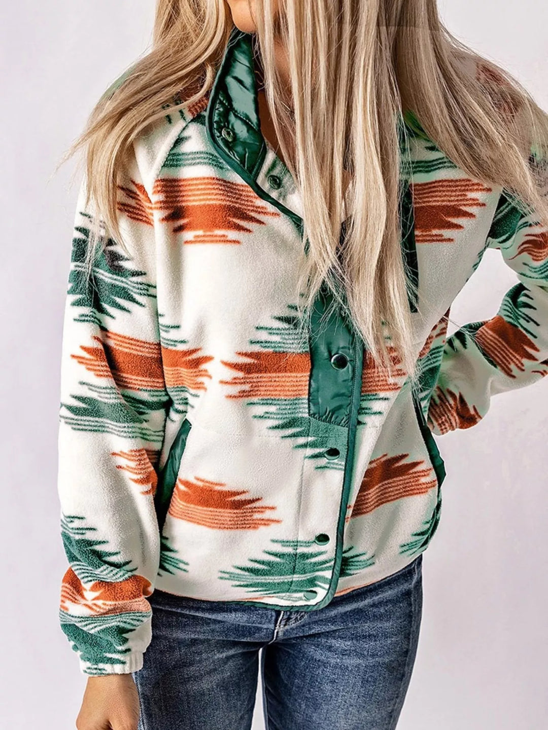Green Aztec print half snap pullover jacket with jeans, front view
