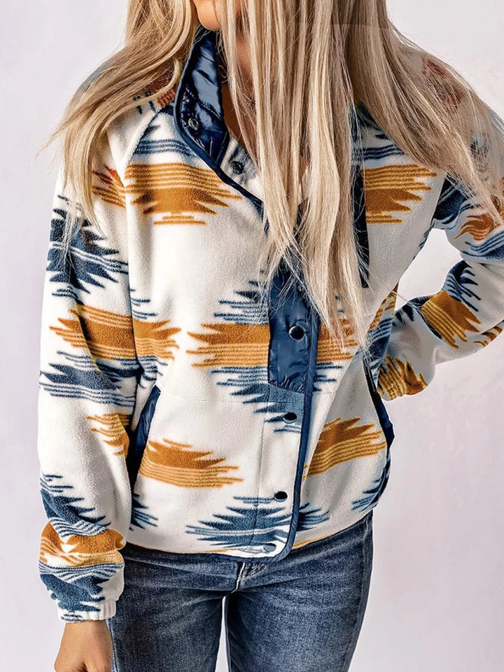 Navy Aztec print fall jacket with long loose hair and jeans, front view