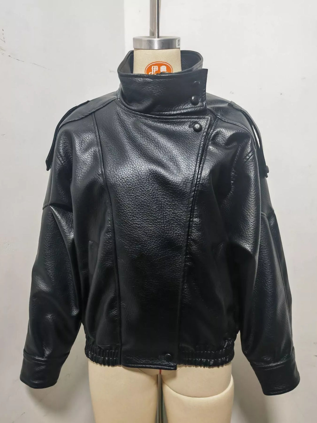 Black funnel collar jacket on a mannequin with zip closed up
