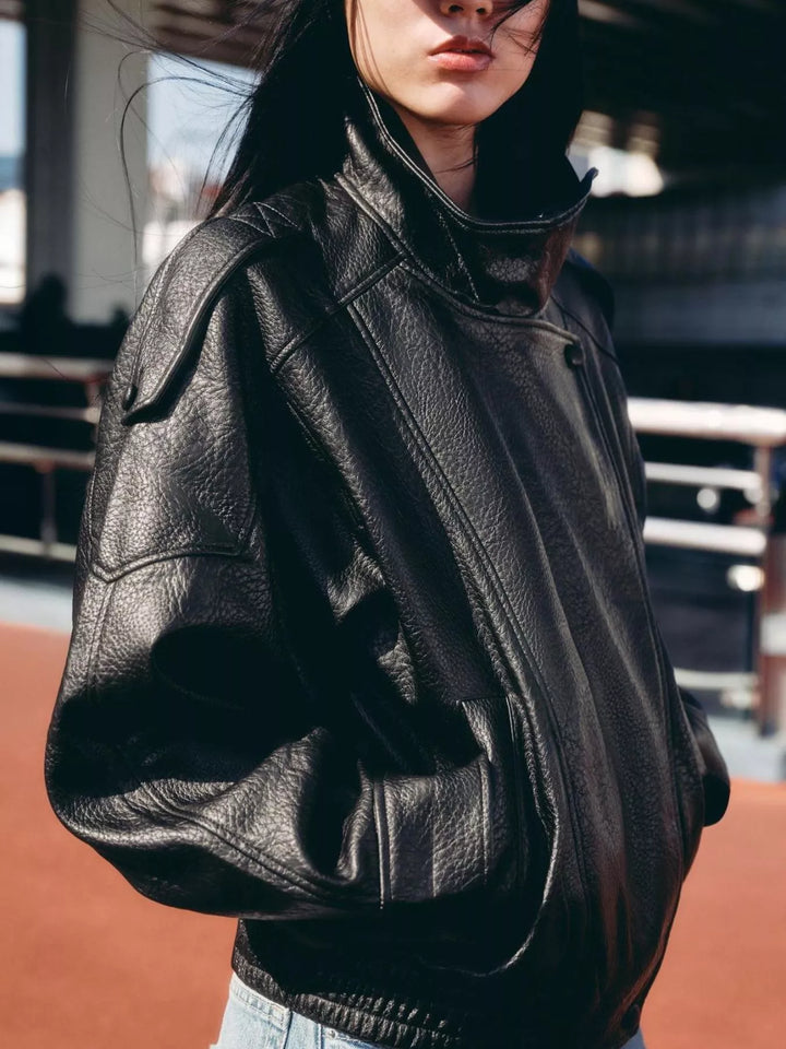 Black oversized moto jacket with hands in pockets and elastic hem
