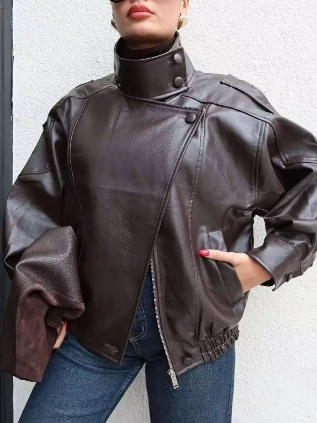 Chocolate funnel collar moto jacket with hand in pocket and jeans